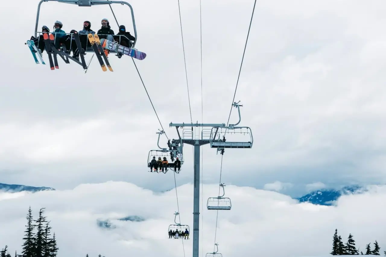 Chairlift above the clouds on a sunny ski day