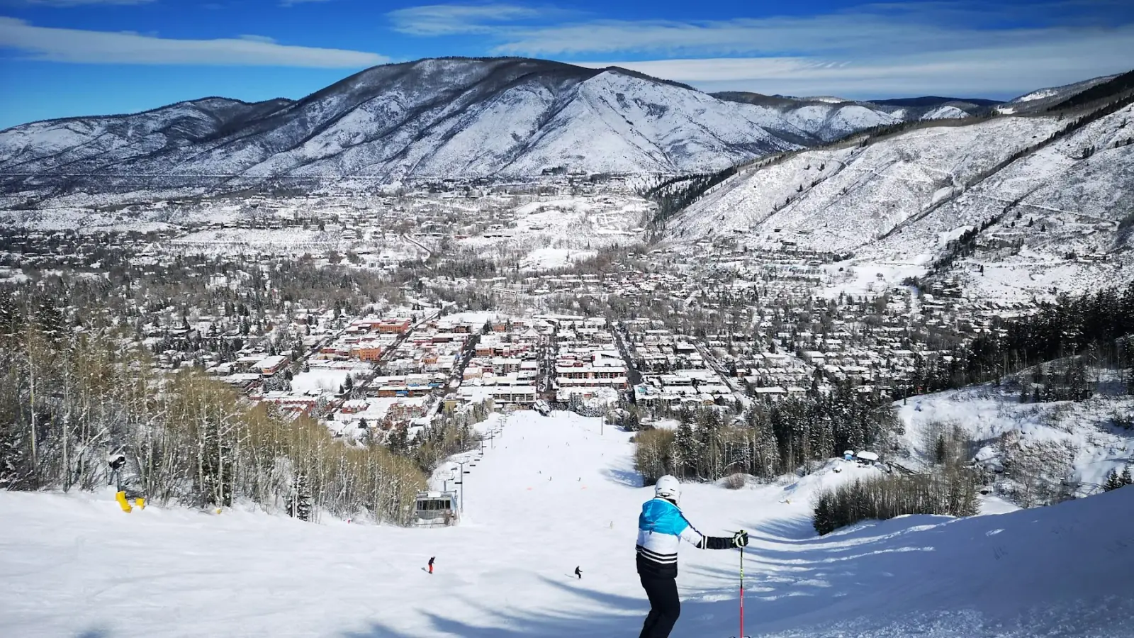 Skier looking out over the town of Aspen from a groomed run